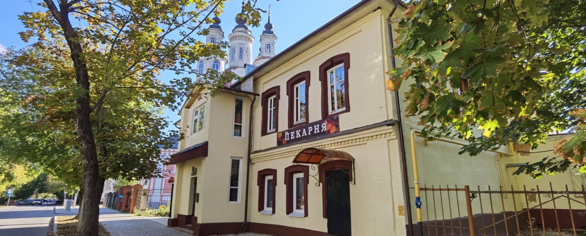 Здание пекарни на фоне храма Космы и Дамиана в Калуге